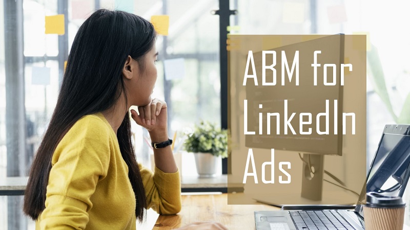 Aligning LinkedIn Ad Spend with Account-Based Marketing (ABM) Target Lists Woman in a yellow sweater sits at a desk, looking at a computer, with a translucent panel reading 'ABM for LinkedIn Ads'.